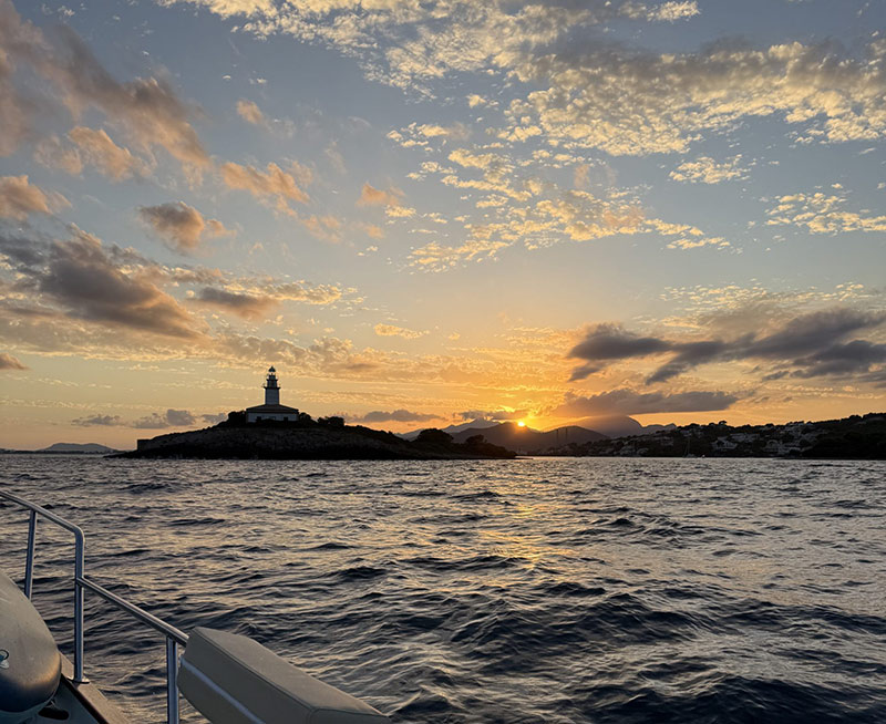 Alcanada Island lighthouse at golden hour sunset Alcudia Bay Mallorca
